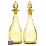 A pair of 19th Century citron glass decanters of shoulder form with basal and shoulder cuts