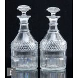 A pair of late Georgian clear crystal Regency cylinder decanters, circa 1810, basal mitre cuts