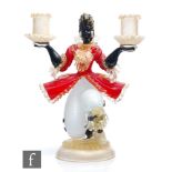 A 20th Century Murano glass figure kneeling, in period dress picked out in red and white with gold