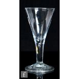An oversized 18th Century goblet circa 1740, the large two piece funnel bowl above a plain stem with