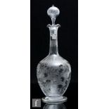 A late 19th Century Aesthetic glass decanter, circa 1880, of footed ovoid form with collar neck, the