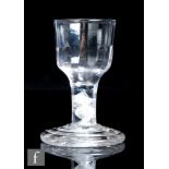 An 18th Century drinking glass, circa 1765, the ogee form bowl with basal fluting above an opaque