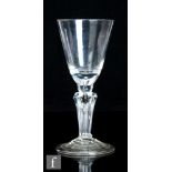 An 18th Century goblet, circa 1720, the round funnel bowl with solid base and integral secondary