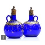 A pair of mid 19th Century Bristol blue finger loop flagon decanters, each of compressed form with