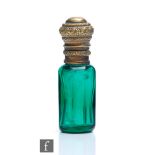 A small 19th Century faceted green glass scent bottle, glass body below gilt metal foliate