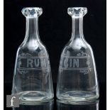 A pair of 19th Century spirit carafes of shoulder form below a slice cut neck with facet cut