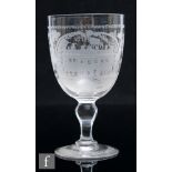 A late 19th Century commemorative clear crystal glass goblet, the large round funnel bowl engraved