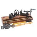 A small Cyclo hand crank operated lathe, length 25cm, a similar lathe, a mahogany cased brass rule