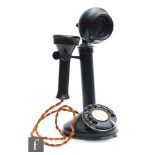 A GEC style black painted candlestick telephone with adjustable speaker, height 30cm.