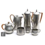 An Art Deco pewter hammered coffee pot and hot water pot, height 22cm, also a matching sugar basin