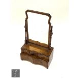 A late 18th to early 19th Century serpentine shaped dressing table mirror, the shaped plate over