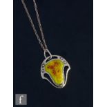 An early 20th Century silver pendant with red and yellow central enamelled panel, length of