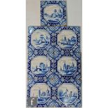 Seven Dutch Delft 6 inch tiles each decorated with landscape scenes against a patterned ground. (7)