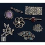 Eight assorted silver brooches to include marcasite set and stone set examples, some hallmarked some