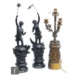 A pair of 19th Century French black painted spelter figures, one holding a star the other a flag,