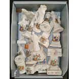 A collection of assorted early 20th Century novelty crested china to include a man in the stocks '