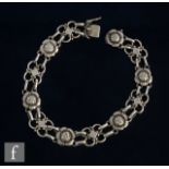 A Danish silver foliate bracelet designed as alternating quatrefoil links between blossoming