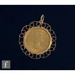 An Elizabeth II full sovereign dated 1958, loose to a 9ct scroll mount, total weight 11.9g.