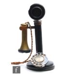 A black painted candlestick telephone with brass detachable speaker marked T E 234, no 22, height
