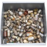 A collection of assorted thimbles to include advertising, wooden, base metal and approximately fifty