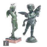 A 20th Century green bronzed spelter study of a winged amorini holding a fish, standing on a dome