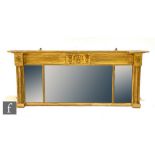 A 19th Century over mantel mirror, the inverted breakfront top over a triple plate centred with a