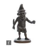 A 19th Century bronze spill holder modelled as Mr Punch, with hinged head and holding a feather