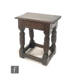 A late 17th Century oak joint stool, the moulded edge top over a dog tooth carved frieze on