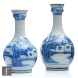 Two Chinese Qing Dynasty (1644-1912) blue and white bottle vases, the fluted rim extending to a