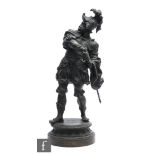 A late 19th Century spelter figure of a helmeted conquistador in full armour and drawing his