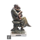 A late 19th to early 20th Century bronzed spelter study of a seated mother and child, after A. J.