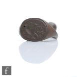 A 17th Century copper alloy pipe tamper in the form of a signet ring with seal matrix incised with a