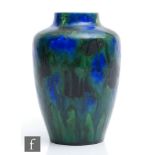 A late 19th to early 20th Century Minton Hollins Astra Ware vase decorated in a streaked blue and