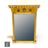 A 19th Century inverted break front wall mirror with ball applied pediment above three later painted