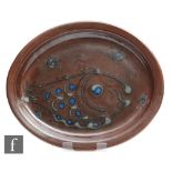 A later 20th Century Winchcombe studio pottery oval dish decorated with a slip trailed fish in