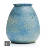 A large Ruskin Pottery vase of swollen form decorated in a mottled blue over a pale yellow ground,