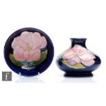 A Moorcroft Pottery vase of compressed form decorated in the Magnolia pattern, impressed mark and