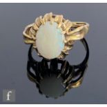 A 9ct hallmarked opal single stone ring, claw set oval stone to leaf set shoulders, weight 3.2g,
