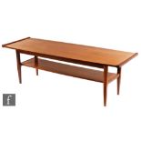 A mid 20th Century teak coffee table, of rectangular form with under-tier, raised to tapered legs,