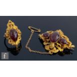 A 19th Century 15ct oval brooch with three foil back red stones and plaited hair panel to reverse,