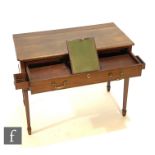 A George III mahogany writing table, the plain top over a long frieze drawer fitted with a green
