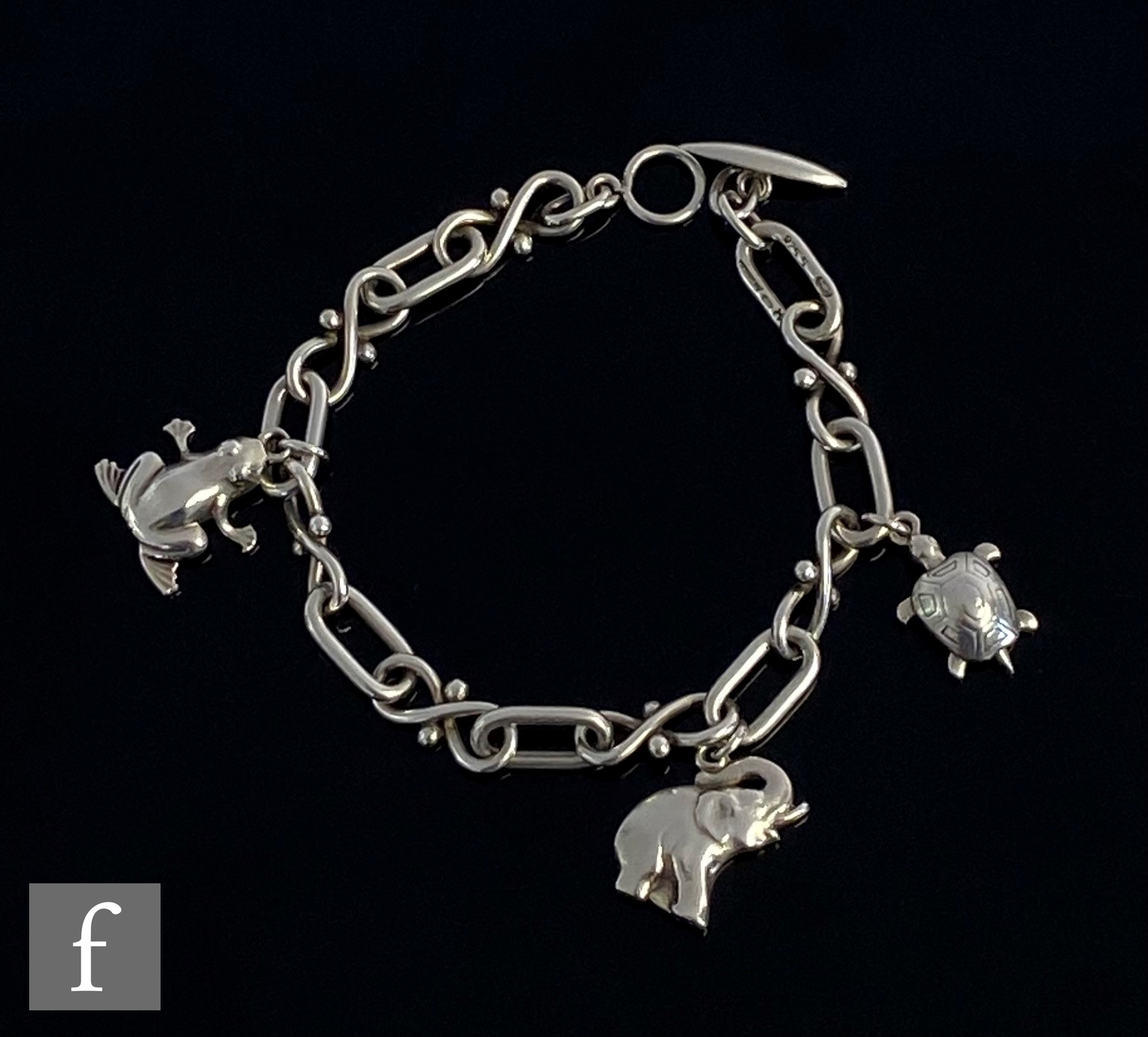 A Danish silver cable link bracelet terminating in t-bar and eye clasp with three animal charms