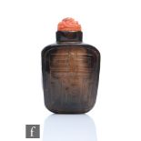 A Chinese 19th Century smoky quartz snuff bottle of rounded rectangular form, each opposing face