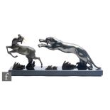 A 20th Century Art Deco spelter study of a leaping leopard hunting a gazelle, on a black marble