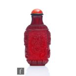 A Chinese ruby-glass snuff bottle, carved and incised to the exterior with two opposing four-claw