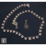 A 19th Century French necklet set with forty four graduated white paste stones, largest stone