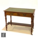 A Victorian converted walnut writing table on turned legs united by an undertier, below a green