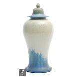 A Ruskin Pottery Mei Ping shaped vase and cover decorated in a glossy light green to matt dark