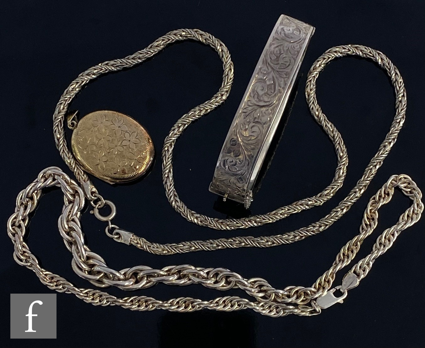 Four items of hallmarked silver jewellery, two chains, a hinged bangle and a gilt oval locket, total