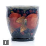 A small Moorcroft fern or plant pot decorated in the Pomegranate pattern with a band of open and